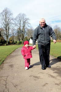 grandfather and grandaughter walking